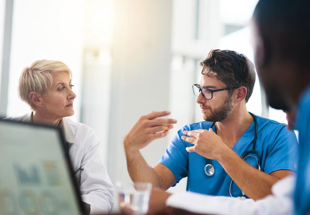 Medical professional explaining something to doctor
