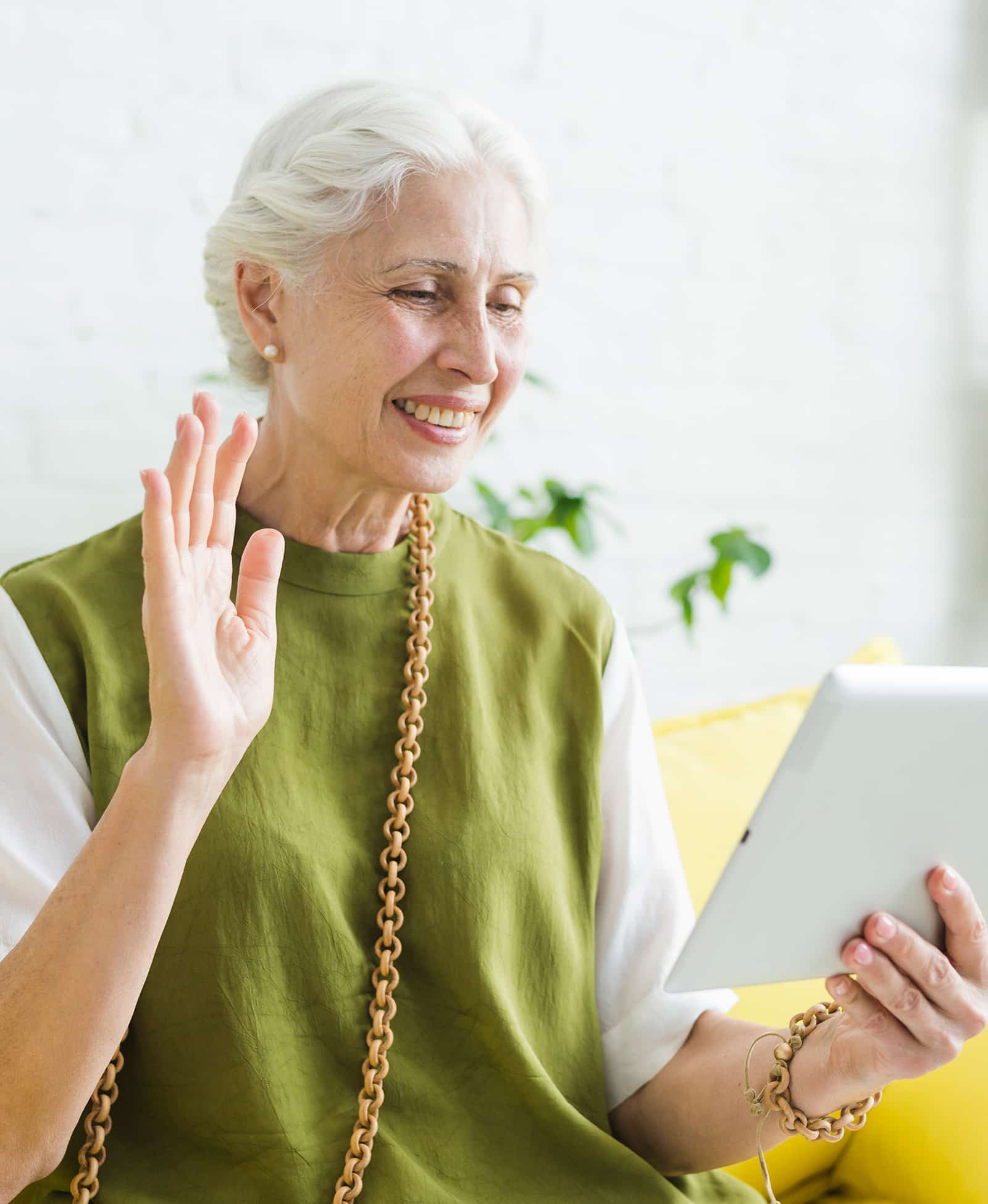 Woman waving with iPad