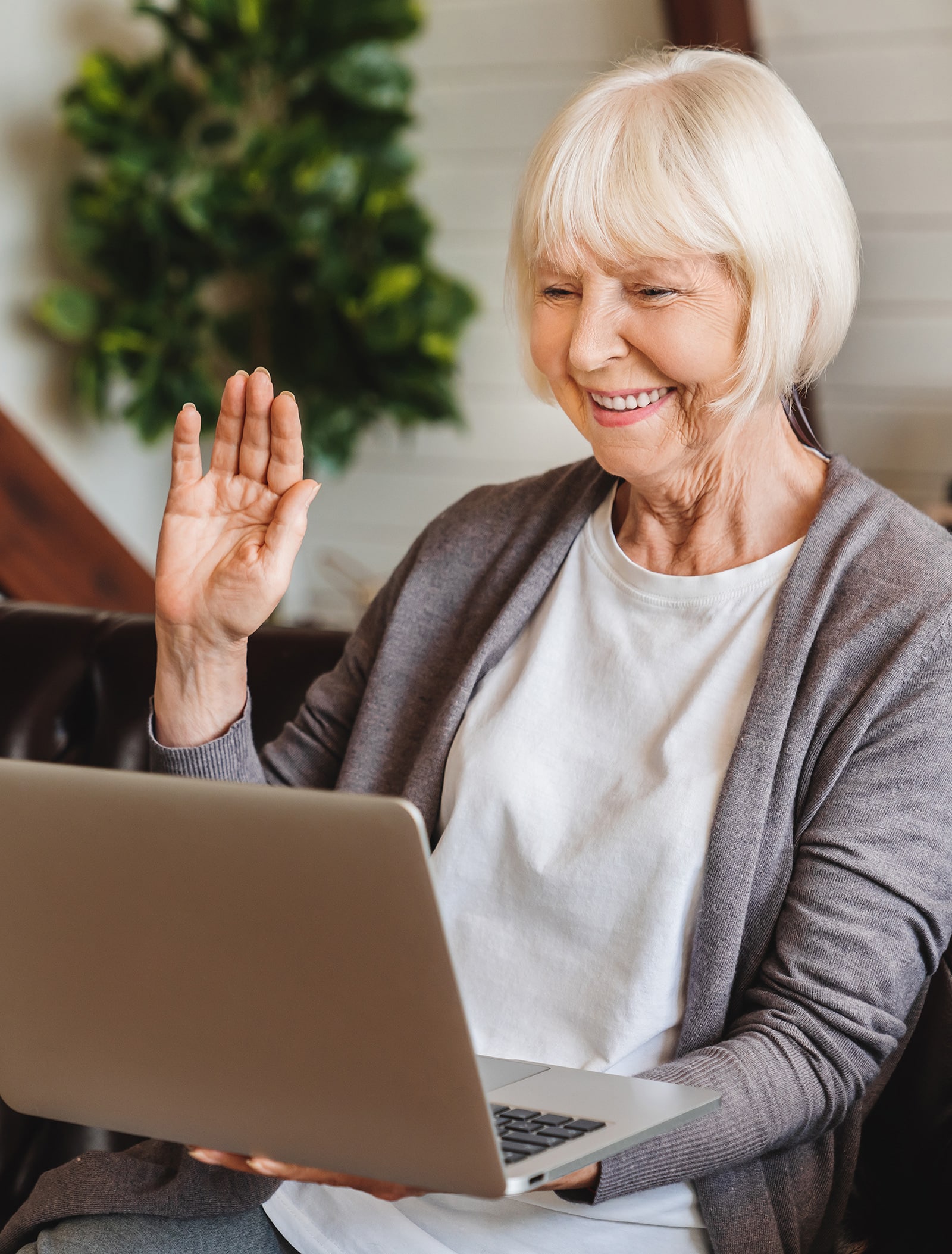 Woman waving on telehealth call