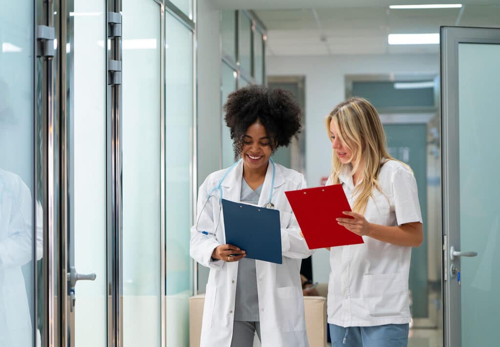Doctors collaborating standing in hallway